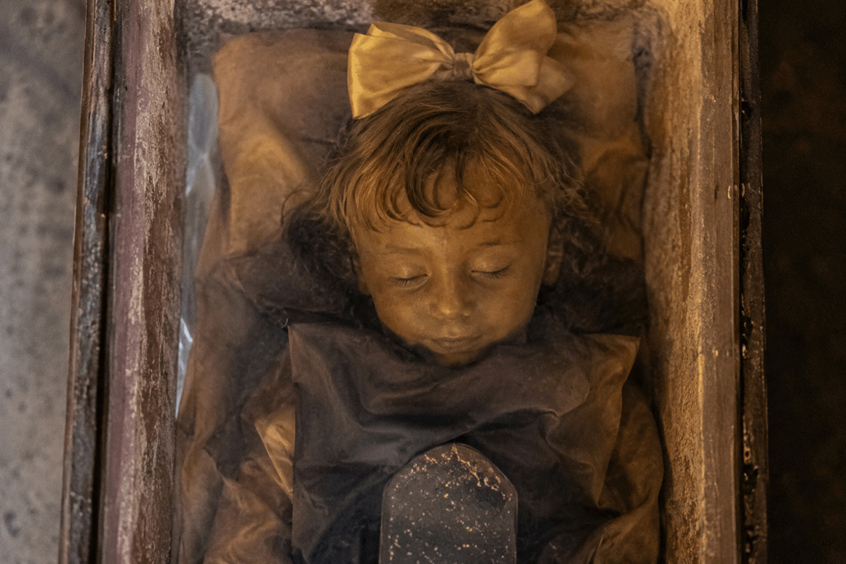 rosalia lombardo story, the corpse that wouldn't decompose, rosalia lombardo preserved body, sleeping beauty of palermo, rosalia lombardo mystery explained, capuchin catacombs sicily, capuchin catacombs palermo italy, real mummy that looks alive, world's best preserved mummy, rosalia lombardo eyes opening myth, creepy true stories from history, haunting historical mysteries, unexplained preservation cases, famous mummies around the world, child mummy in sicily, eerie places in italy, strange true stories that sound fake, historical mysteries still unsolved, paranormal legends of italy, rosalia lombardo embalming technique, alfredo salafia embalming formula, preserved corpse mystery, chilling stories based on real events, macabre tourist attractions in europe, unsettling historical discoveries, famous catacombs in the world, real life horror stories, bizarre historical facts, strange deaths in history, creepy places tied to legends, world's most haunting mummies, true mystery stories for adults, famous preserved bodies in history, sicily tourist attractions mystery, sleeping beauty mummy story, historical paranormal legends, unexplained phenomena in catacombs, dark tourism destinations europe, real corpse preservation mystery, terrifying true stories from europe.